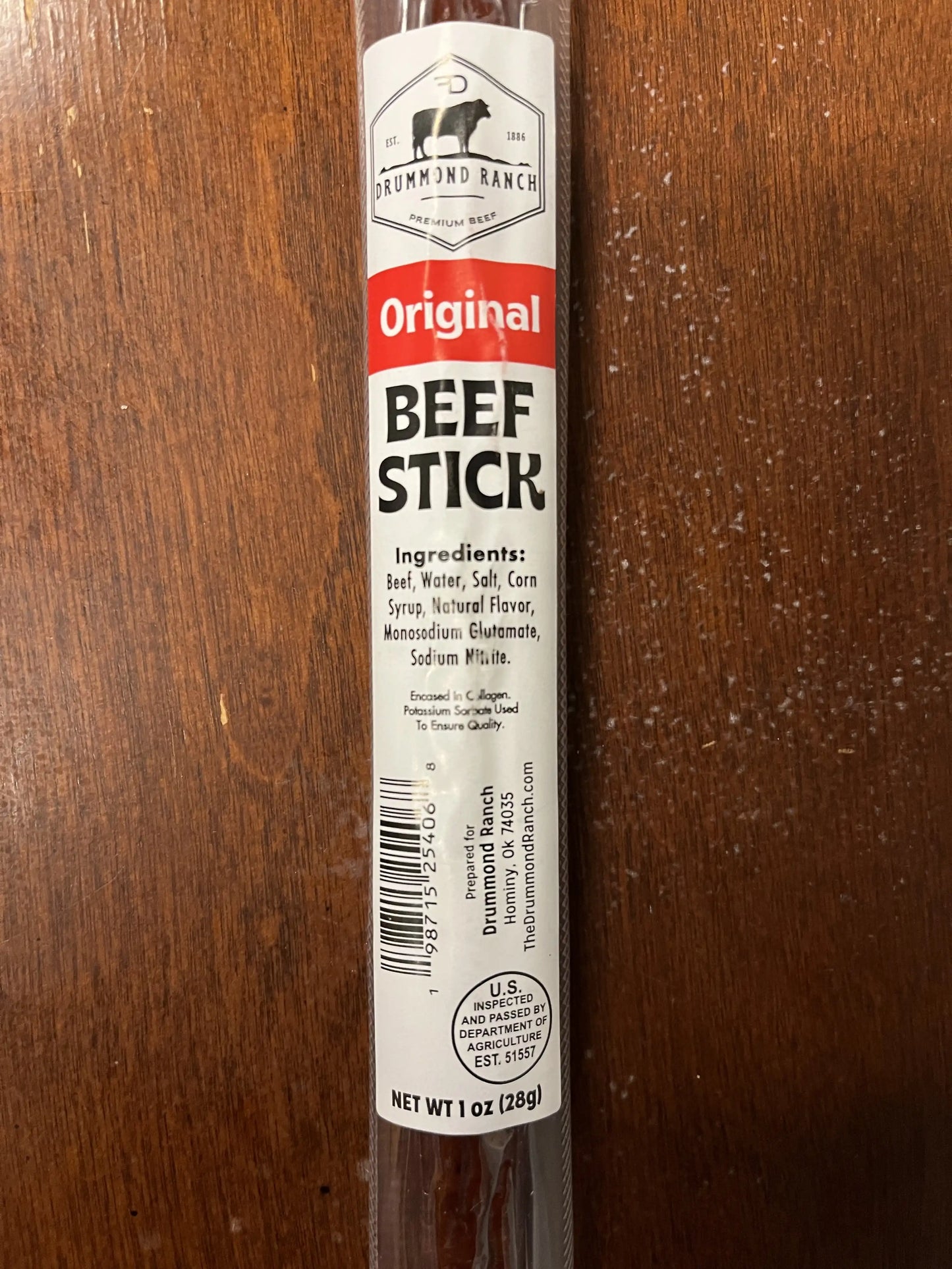 Close-up of an Original flavor beef stick from Drummond Ranch in its packaging, clearly displaying the ingredients and product information.